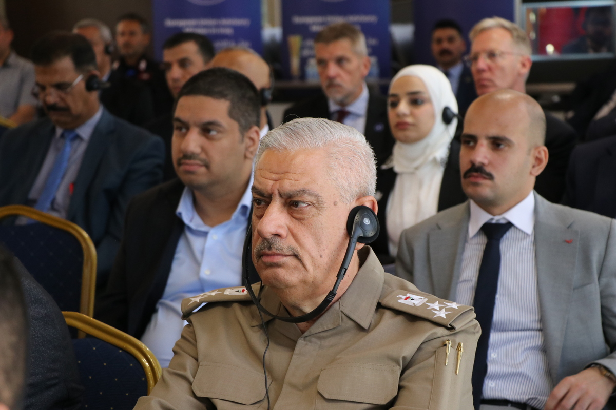 A person in a military uniform with a microphone

Description automatically generated